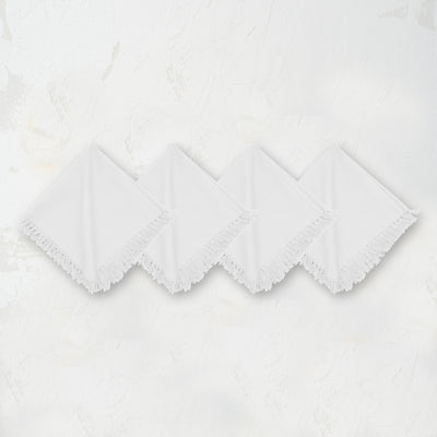 white woven napkin with hand-tied fringe edges