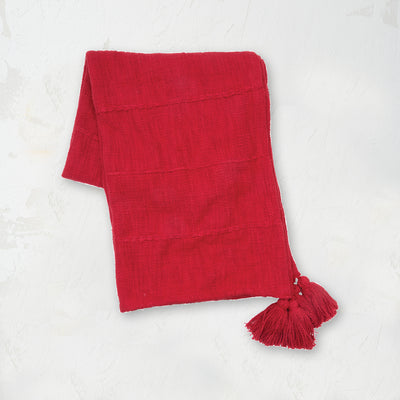 red hand woven throw with fringed edges