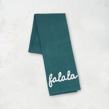 green kitchen towel with the word falala in white