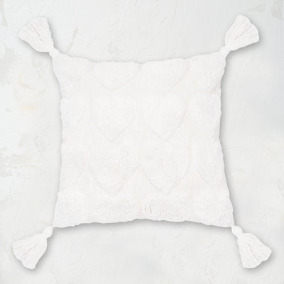 white pillow with tufted hearts and fringed tassel edges