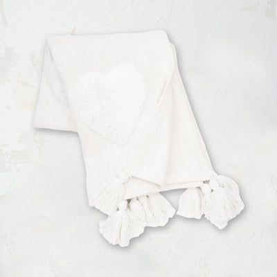 white throw with tufted hearts and fringed tassel edges