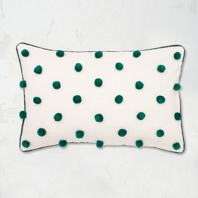 Jungle Dot Oblong Pillow with pom pom embellishments in classic polka dot style with matching border.