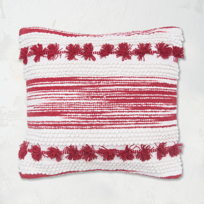 Oriana Ruby Pillow builds a unique pattern through texture with hand woven zig zags and stripes, tufted dots, and hand-tied mini tassels.