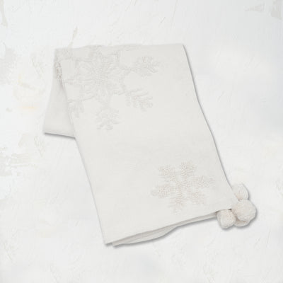 White Snowflake Throw featuring a pom pom corner tassels and a tufted snowflake pattern on high-quality cotton.